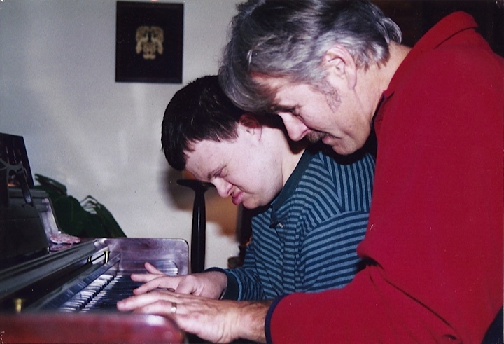 Photo of Mark playing piano with Mike.